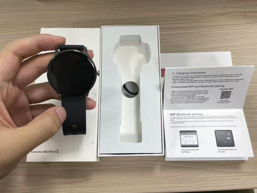 Ultra Slim Smart Watch held next to its packaging and instructions, featuring a sleek design and modern features.