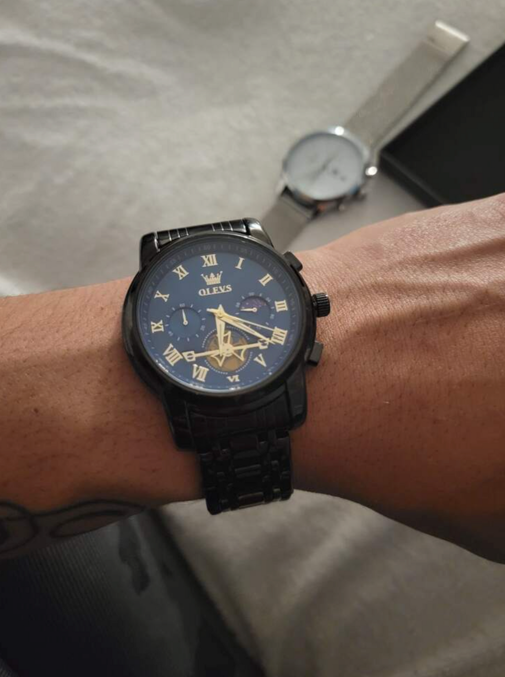  OLEVS watch on black background